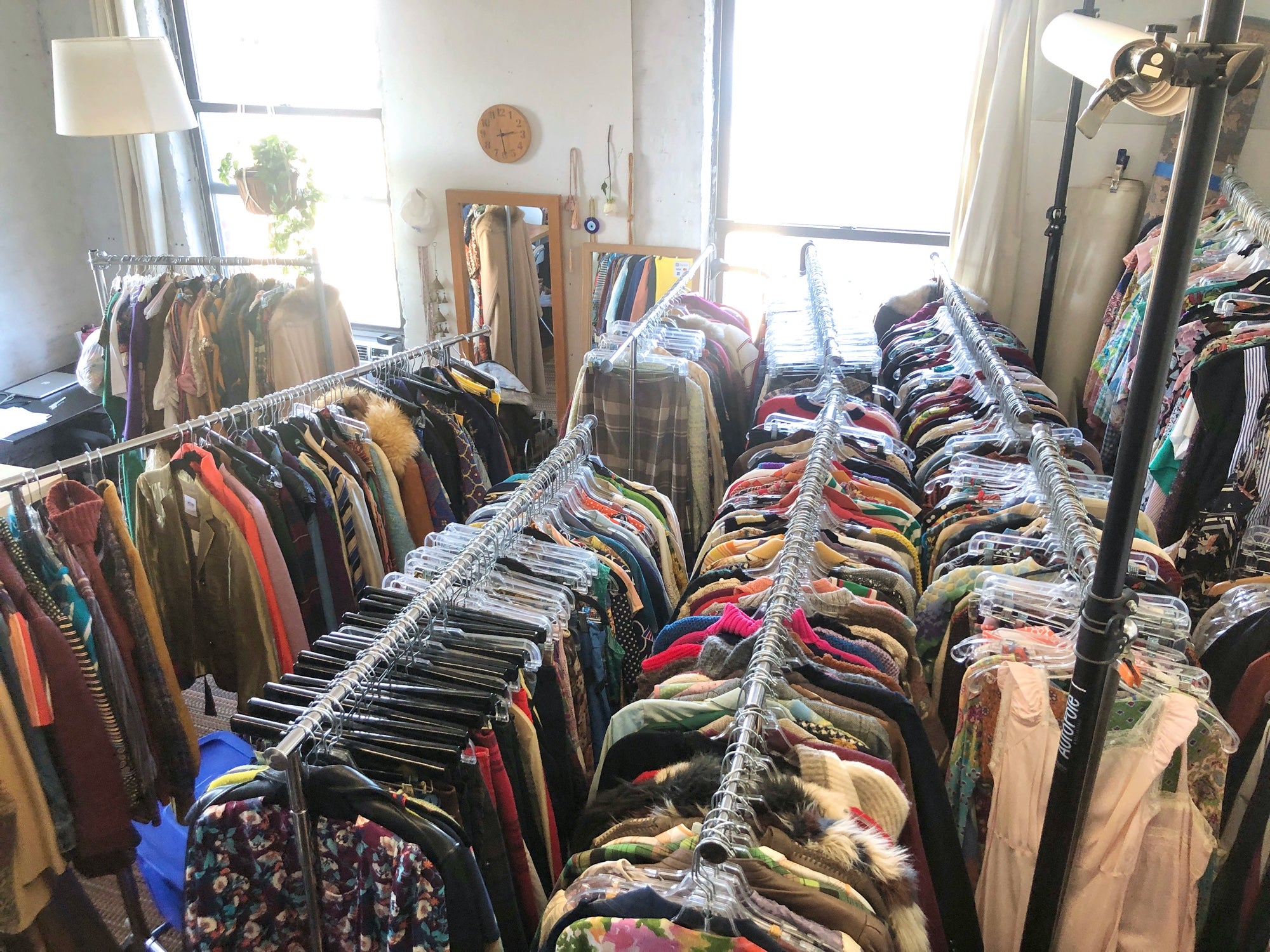 Room filled with racks of vintage clothing
