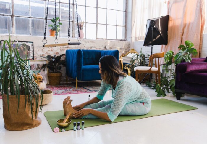 A woman practices yoga in a loft apartment