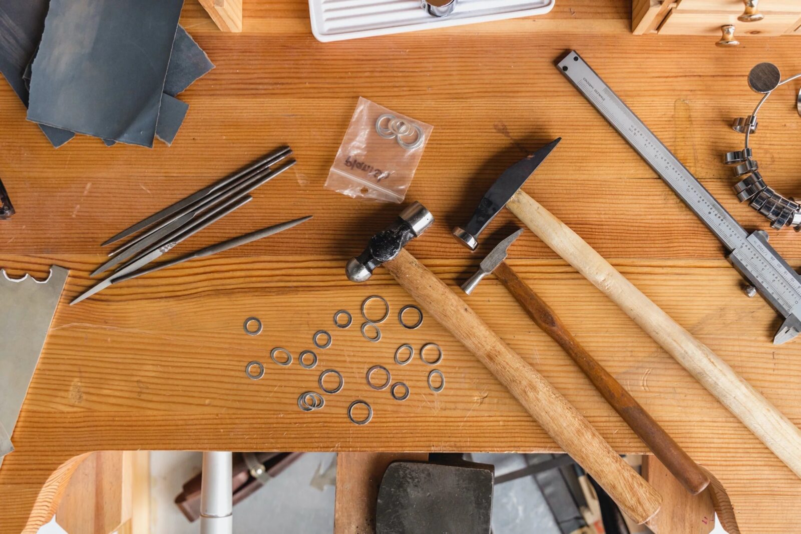 Jewelry-making tools on a wooden table