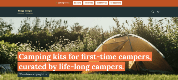 Happy Camper website with Coming Soon banner and countdown timer above photo of a tent