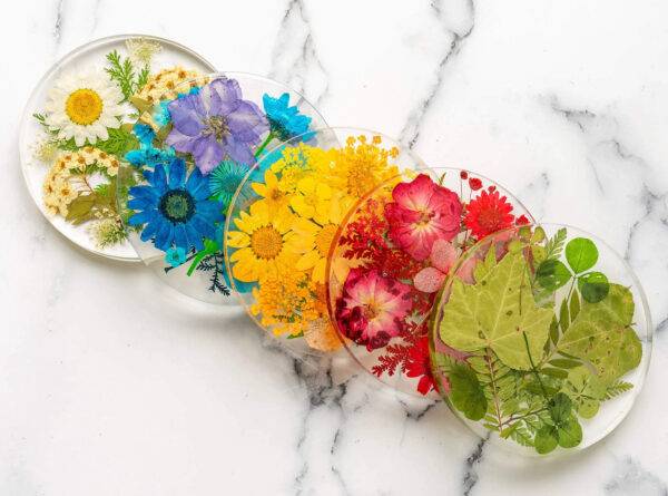 Stack of resin coasters featuring pressed flowers