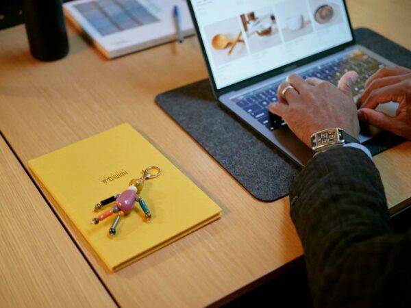 A person sitting at a desk types on a laptop