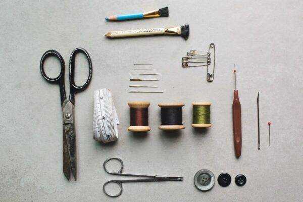 An array of sewing supplies arranged in a flatlay